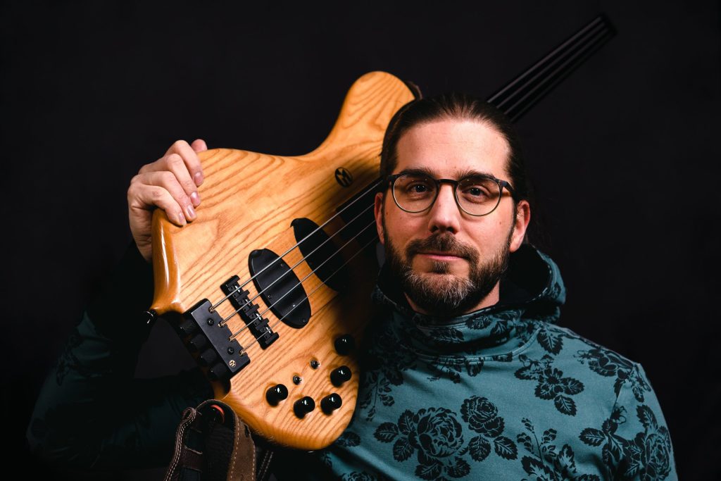 Person holding an electronic bass