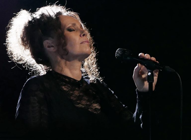 Kirsi Poutanen holding a mic