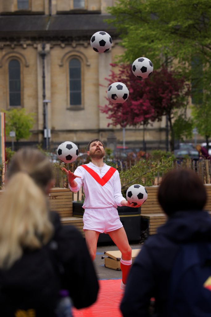Circus Simon juggling soccer balls outdoors