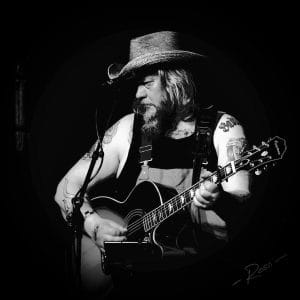 Stenari holding a guitar